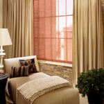 Decorative draperies hung over functional shades are a perfect choice.