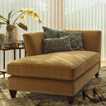 A camel chaise lounge with decorative pillows adds a restful touch.