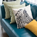 Start your animal accents small with throw pillows.. modern living room with green sofa and pillows at home