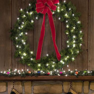 Placing a holiday wreath over your mantel perks up your room.