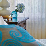 Turquoise accents add sparkle to a bedroom.