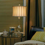 A traditional lamp adds elegance and illumination to a bedroom.