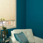 Dramatic blue paint is perfect with white furniture and window shades.