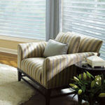 An easy chair in striped pastel fabric communicates calmness.