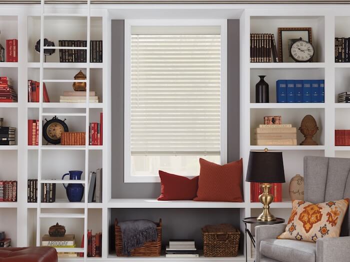 Books sorted by color and size add a finishing touch. Shown with EverWood® Distinctions™ blinds.