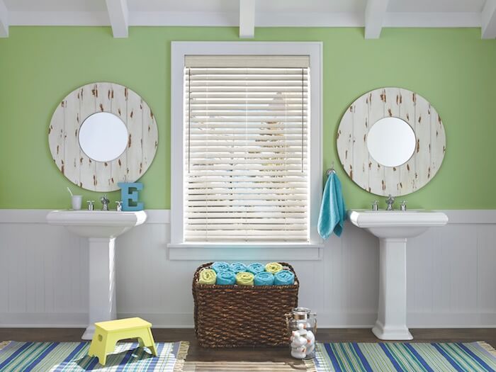 Wainscoting adds a rustic touch to this bathroom. Shown with EverWood® TruGrain® blinds.