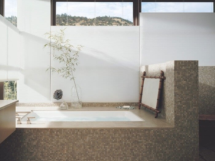 A spa-inspired bathroom. Shown with Duette® honeycomb shades.