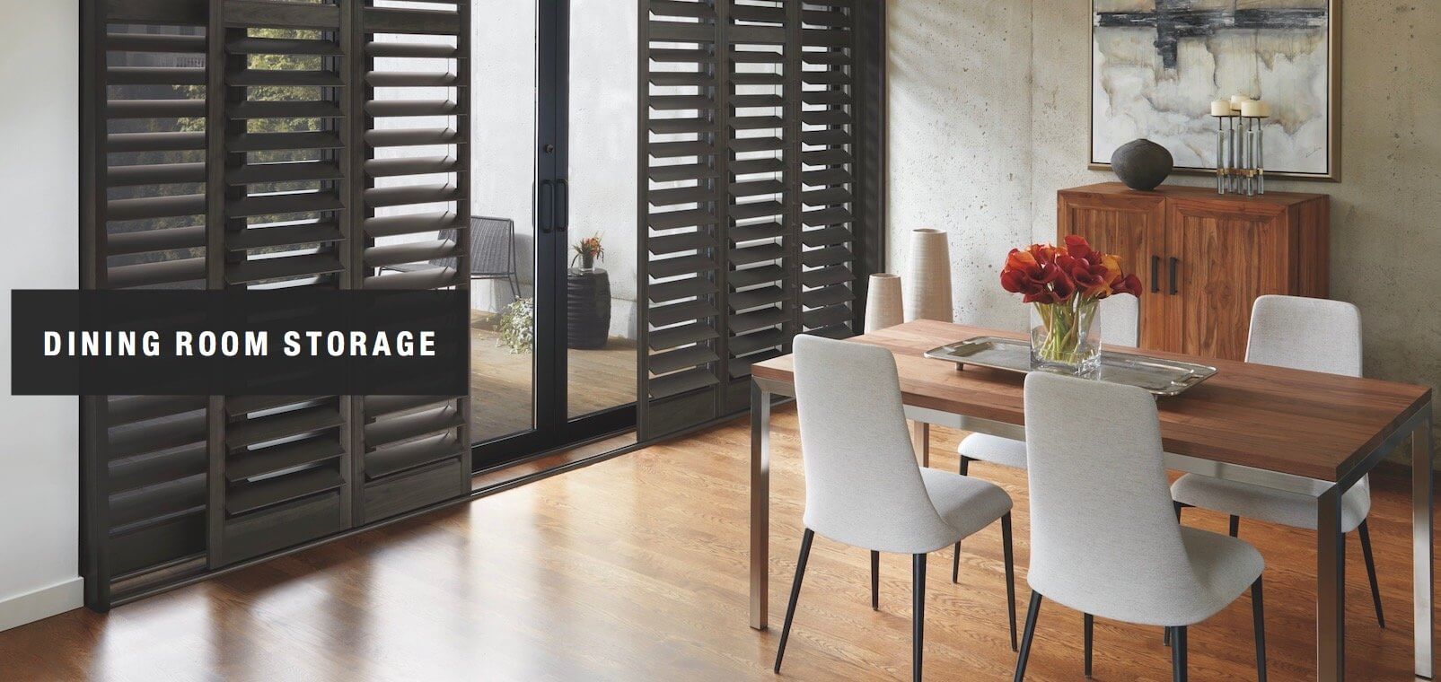 Dining room storage adds beauty and function. Shown with NewStyle™ hybrid shutters.