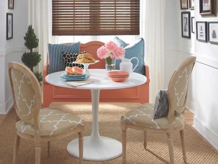 Feeling cautious? Start small with a painted bench and some pillows. Shown with Parkland® Classics™ Wood Blinds.