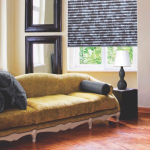 Choose pillow fabrics that are different from your upholstery fabric. Shown with Hunter Douglas Pleated Shades.