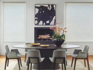 Hang a beautiful piece of art over the fireplace. Shown with Sonnette™ Cellular Roller Shades.
