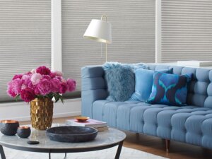 Blue couch with pink flowers in vase